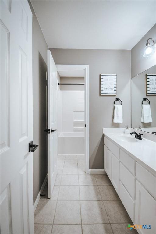 full bathroom featuring vanity, baseboards, and tile patterned flooring