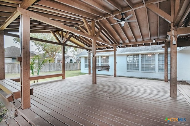 wooden terrace featuring ceiling fan and fence