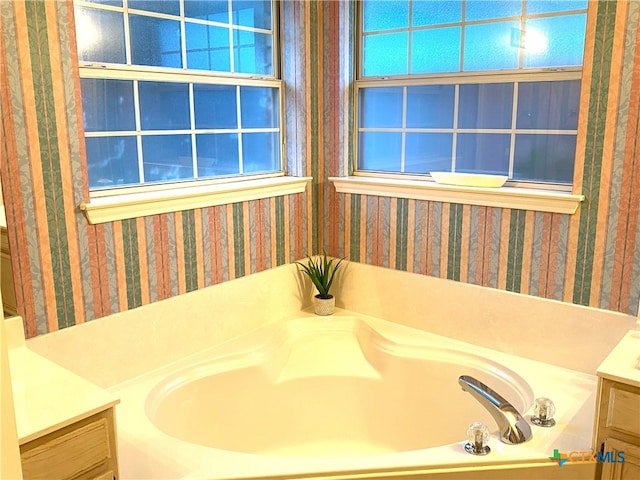 4803 Addie Dr, Killeen, TX 76542 - bathroom with vanity, wallpapered walls, and a garden tub