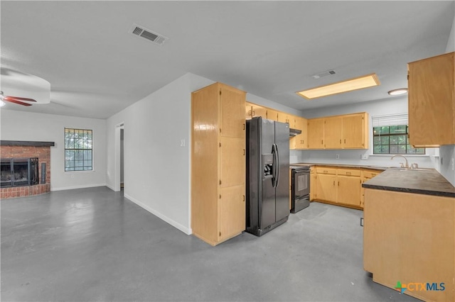 kitchen with black appliances, finished concrete floors, open floor plan, and plenty of natural light