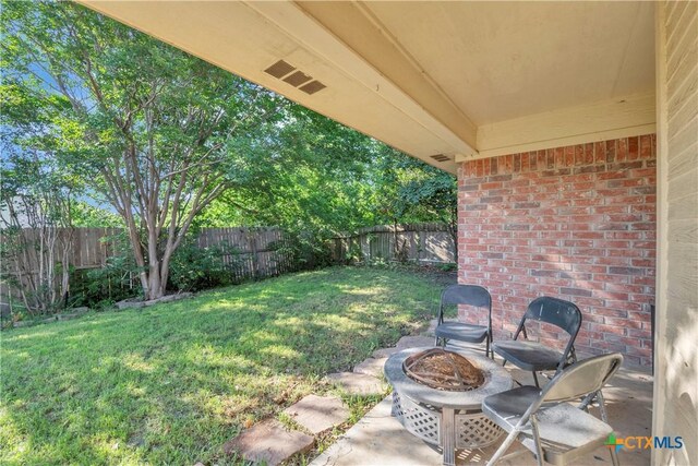 view of yard featuring a fire pit and a patio area
