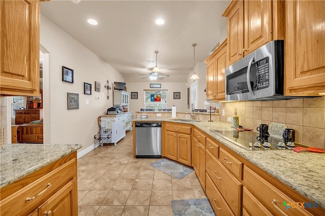 kitchen with stainless steel appliances, decorative backsplash, light stone countertops, and pendant lighting