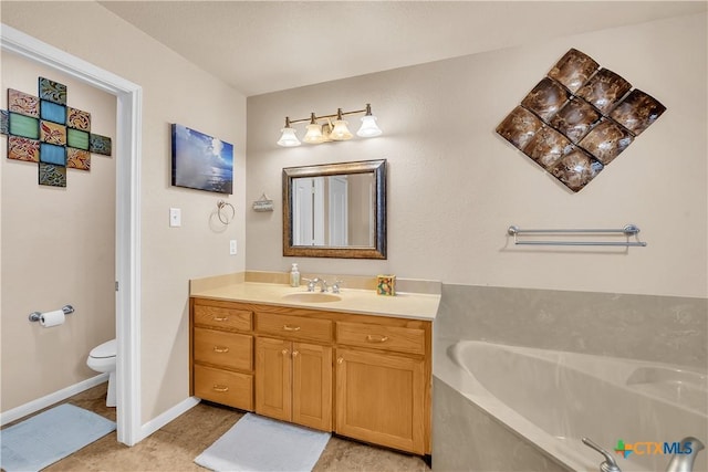 bathroom with baseboards, toilet, a garden tub, tile patterned flooring, and vanity