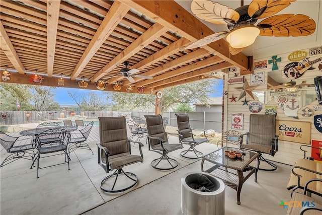 view of patio / terrace with fence, a ceiling fan, and outdoor dining space