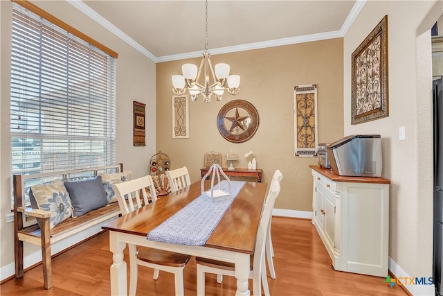 dining space featuring light wood-style floors, baseboards, a chandelier, and crown molding