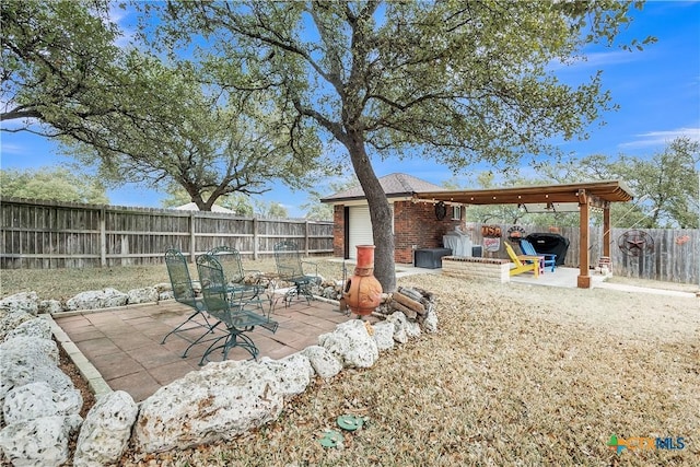 view of patio with a fenced backyard and a grill