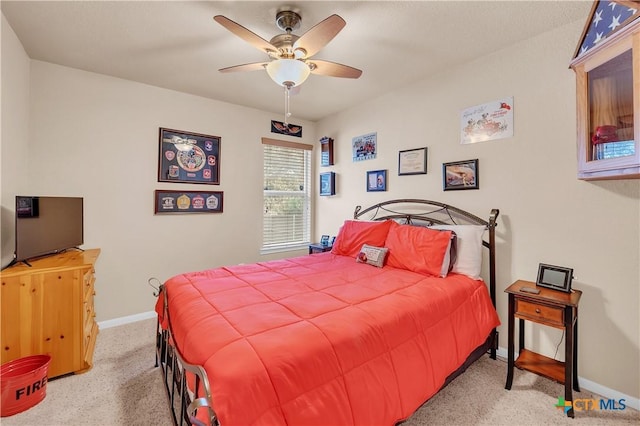 carpeted bedroom featuring ceiling fan and baseboards