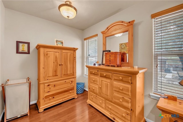 bedroom featuring wood finished floors and baseboards