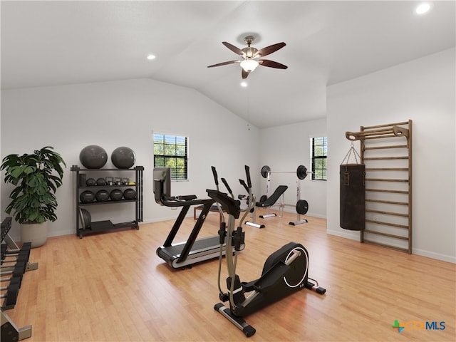 workout room featuring ceiling fan, lofted ceiling, and light hardwood / wood-style flooring