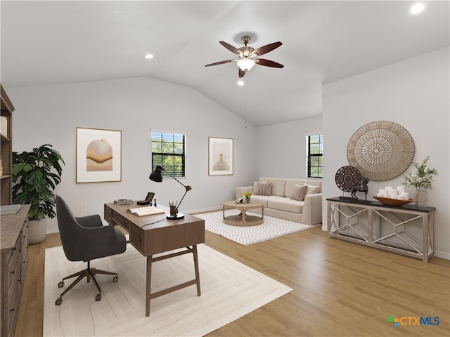 office space with vaulted ceiling, ceiling fan, and light hardwood / wood-style flooring