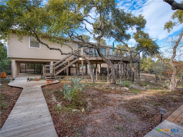 back of house with a wooden deck