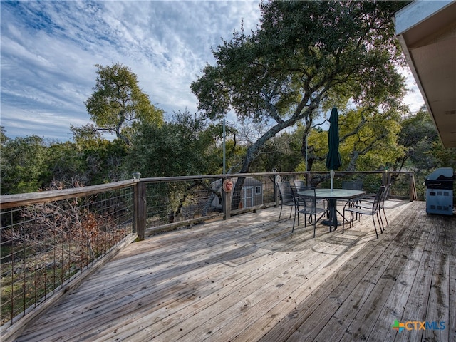 wooden deck featuring a grill