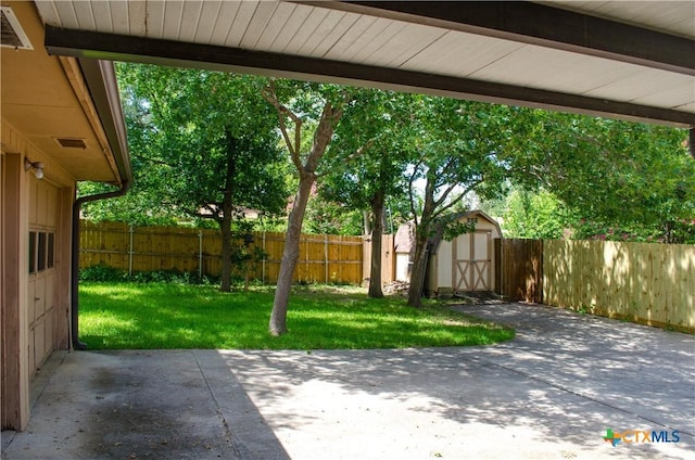 303 E 20th Ave, Belton, TX 76513 - fenced backyard featuring a patio and a storage unit