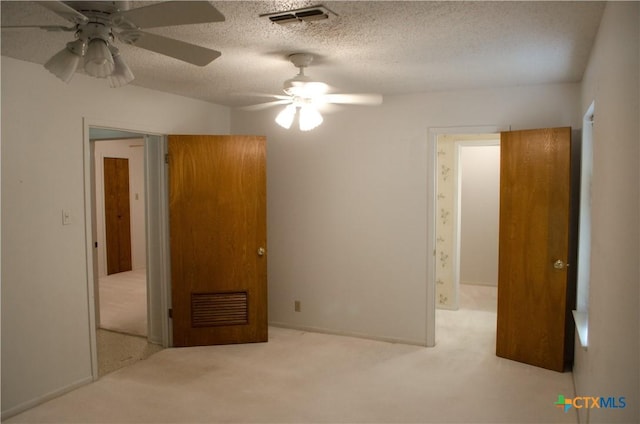 303 E 20th Ave, Belton, TX 76513 - unfurnished bedroom with carpet flooring, a textured ceiling, and a ceiling fan
