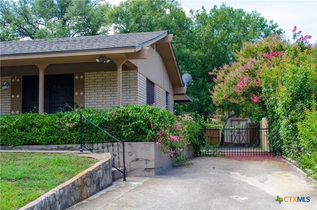 303 E 20th Ave, Belton, TX 76513 - view of home's exterior featuring brick siding and roof with shingles