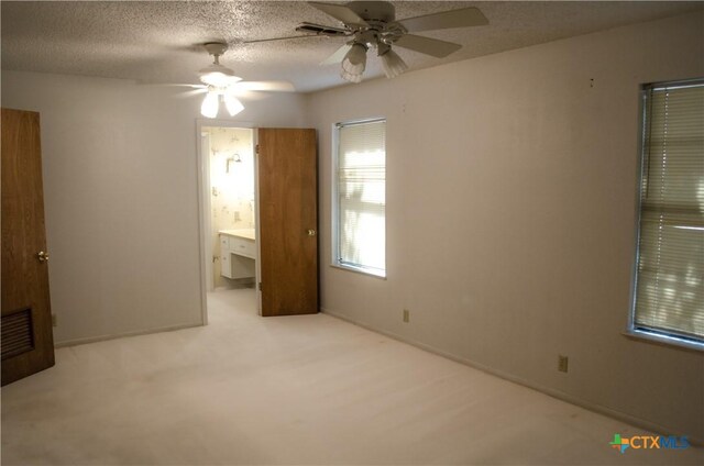 303 E 20th Ave, Belton, TX 76513 - unfurnished bedroom with carpet floors, ceiling fan, and ensuite bathroom