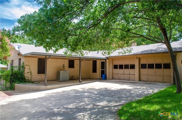303 E 20th Ave, Belton, TX 76513 - single story home with a garage, driveway, a chimney, and brick siding