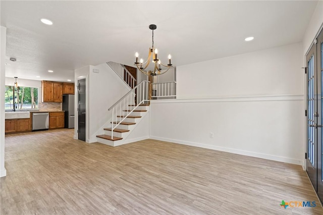 910 Cliffside Dr, Harker Heights, TX 76548 - unfurnished living room with a chandelier, light wood finished floors, recessed lighting, stairs, and baseboards