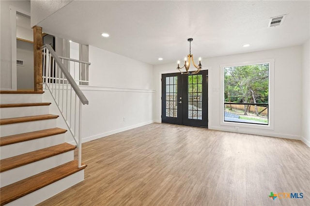 910 Cliffside Dr, Harker Heights, TX 76548 - unfurnished living room featuring wood finished floors, a chandelier, baseboards, stairway, and recessed lighting