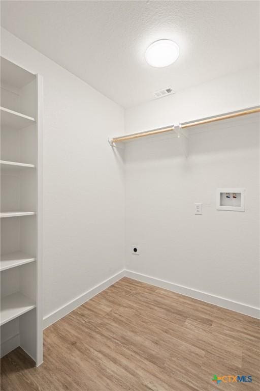 910 Cliffside Dr, Harker Heights, TX 76548 - washroom with hookup for a washing machine, wood finished floors, baseboards, built in features, and electric dryer hookup