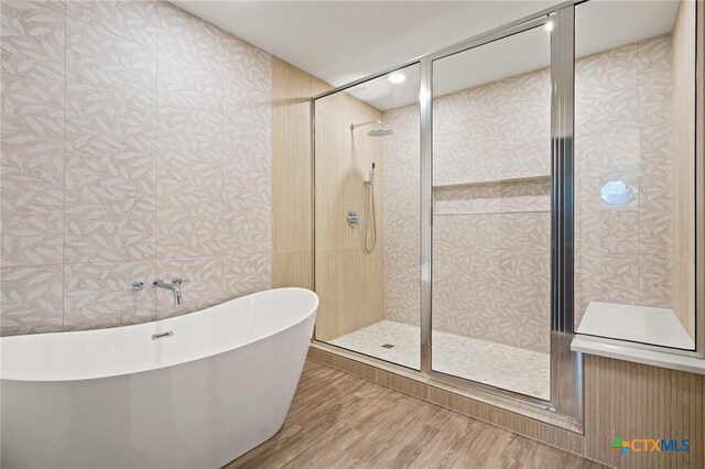 910 Cliffside Dr, Harker Heights, TX 76548 - full bath with a freestanding tub, a shower stall, wood finished floors, wallpapered walls, and recessed lighting