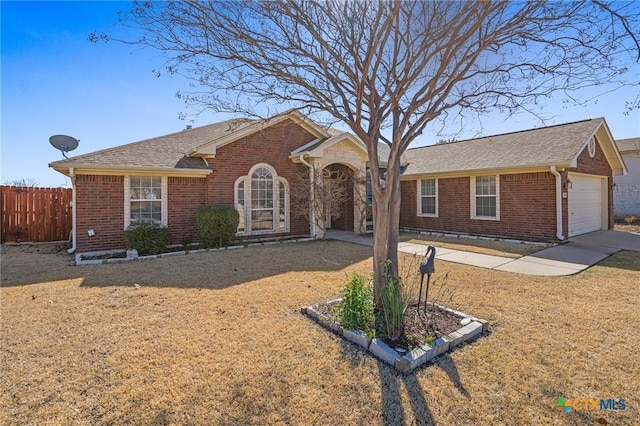 ranch-style house featuring a garage and a front yard