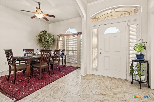 entrance foyer featuring crown molding and ceiling fan