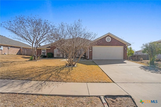 single story home featuring a garage and a front lawn