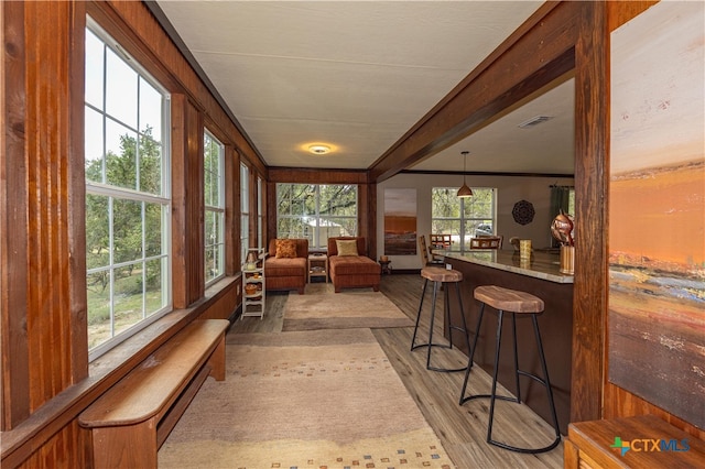 sunroom featuring beamed ceiling