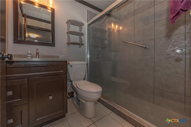 bathroom featuring tile patterned flooring, vanity, crown molding, a shower with shower door, and toilet