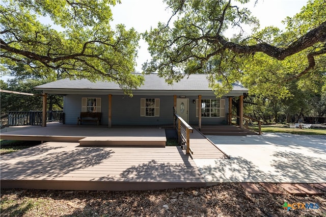 rear view of property featuring a deck