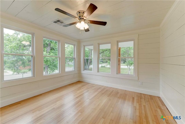 unfurnished sunroom featuring ceiling fan and visible vents