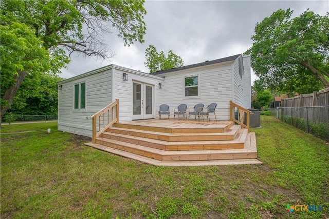 back of house with french doors, a lawn, a fenced backyard, and a wooden deck