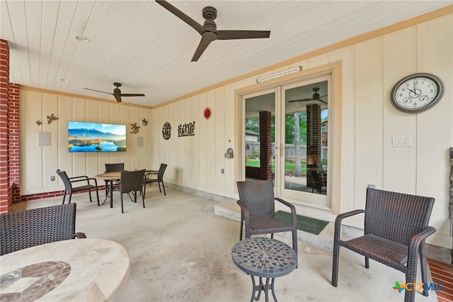 view of patio with french doors, a ceiling fan, and outdoor dining space
