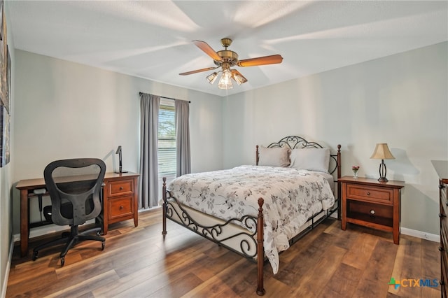 bedroom with baseboards, wood finished floors, and a ceiling fan