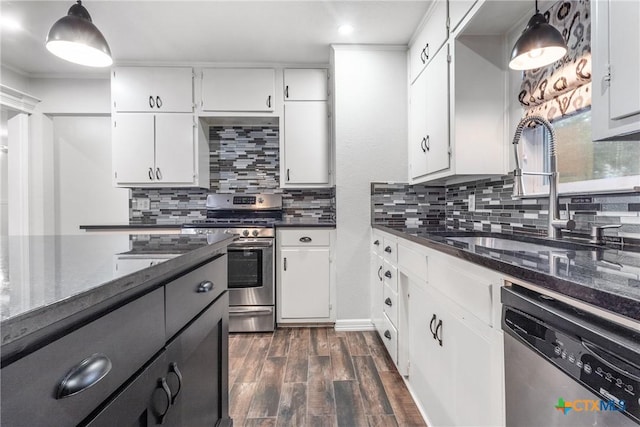 kitchen featuring dark wood-style floors, tasteful backsplash, stainless steel appliances, and a sink