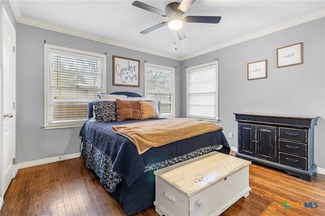 bedroom with a ceiling fan, crown molding, baseboards, and hardwood / wood-style floors