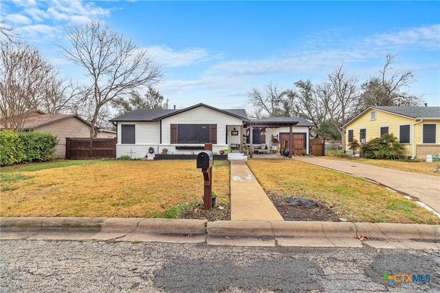 view of front of property with a front yard and fence