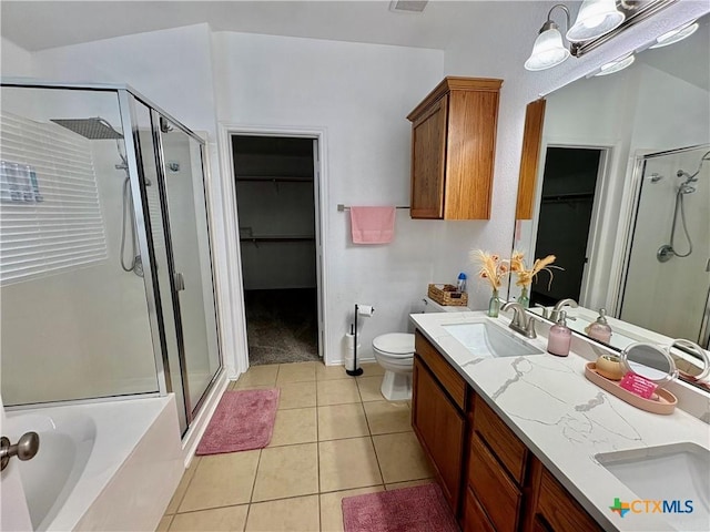 5902 Chuckwagon Cir, Killeen, TX 76542 - bathroom with a walk in closet, a stall shower, double vanity, and tile patterned floors