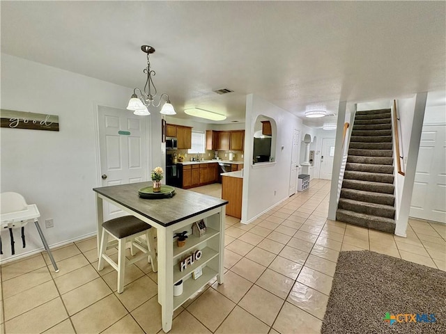 5902 Chuckwagon Cir, Killeen, TX 76542 - dining space featuring light tile patterned floors, stairs, baseboards, a chandelier, and arched walkways