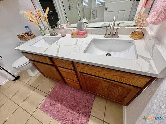 5902 Chuckwagon Cir, Killeen, TX 76542 - full bathroom with tile patterned floors, double vanity, toilet, and an enclosed shower