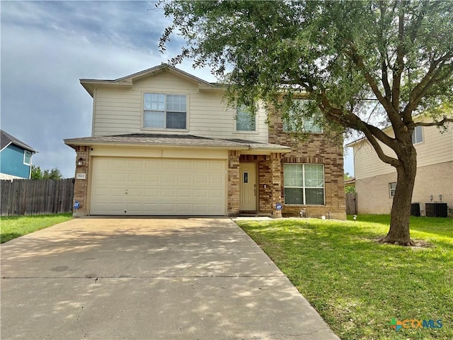 5902 Chuckwagon Cir, Killeen, TX 76542 - traditional-style house featuring concrete driveway, central AC unit, brick siding, and a garage