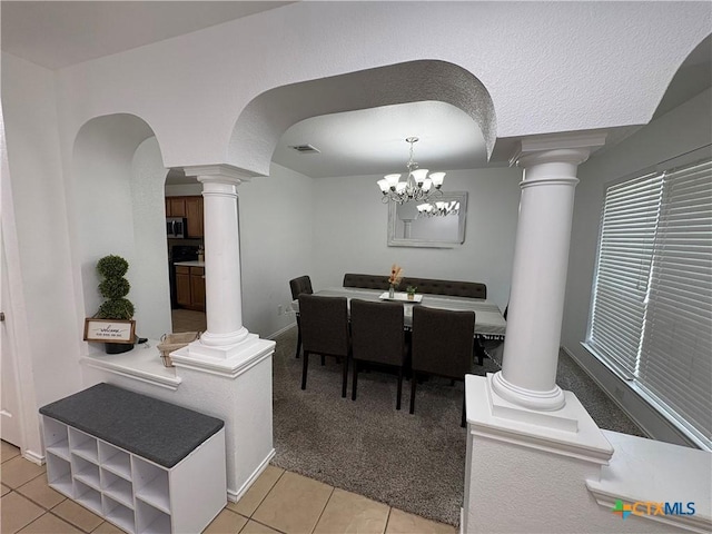 5902 Chuckwagon Cir, Killeen, TX 76542 - dining area featuring ornate columns, light tile patterned floors, arched walkways, and a chandelier