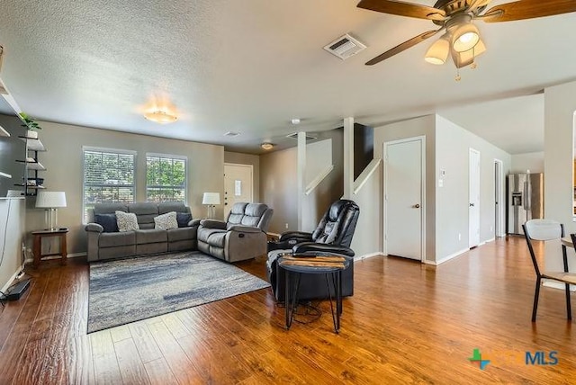 25923 Torch Lily, San Antonio, TX 78260 - living area featuring wood finished floors, ceiling fan, baseboards, and a textured ceiling