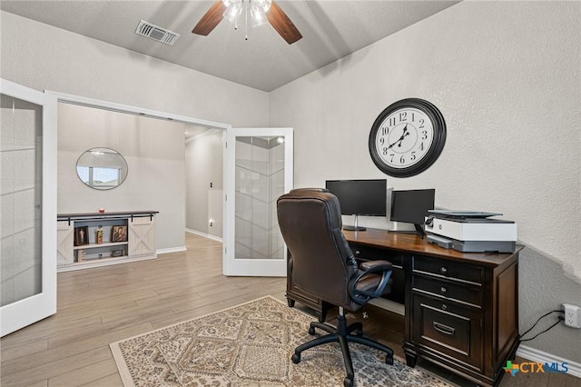 home office with ceiling fan, light wood-type flooring, and french doors