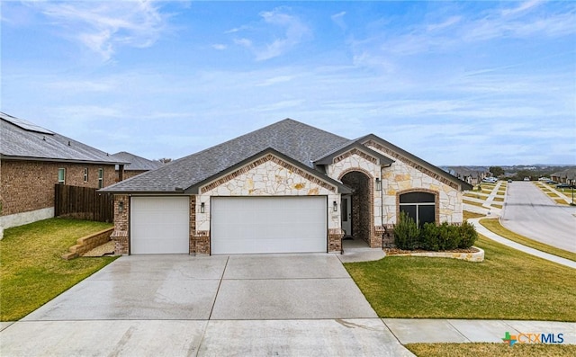 view of front of property featuring a garage and a front yard