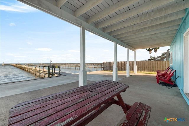 view of patio / terrace with a boat dock and a water view