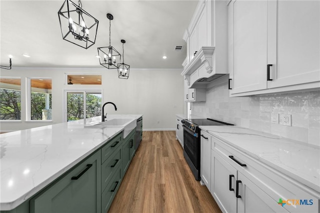 15938 Salado Dr, Temple, TX 76502 - kitchen featuring electric range, wood finished floors, white cabinetry, stainless steel dishwasher, and backsplash