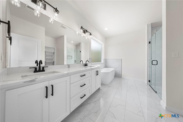 15938 Salado Dr, Temple, TX 76502 - full bath featuring marble look tiles, a shower stall, double vanity, and a soaking tub
