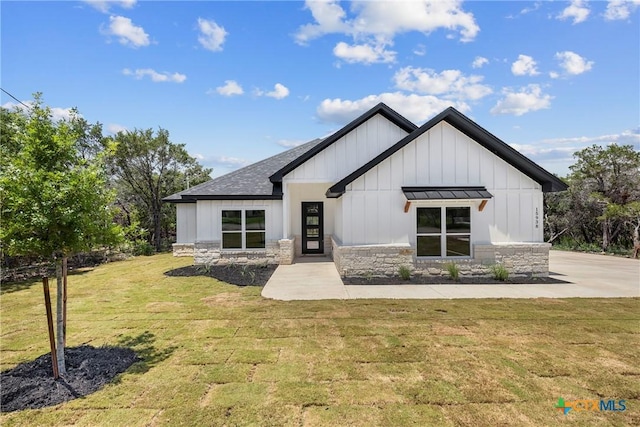 15938 Salado Dr, Temple, TX 76502 - view of front facade featuring board and batten siding, stone siding, a front lawn, and roof with shingles